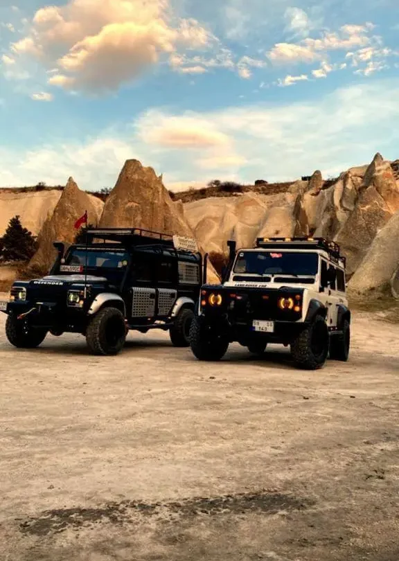 Luxury 4x4 off-road vehicle driving through the Red and Rose valleys in Cappadocia.